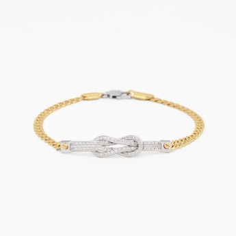 Bracciale da uomo in oro giallo con nodo nautico centrale.